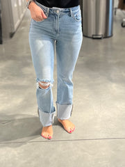 girl wearing high rise light wash denim jeans with large cuff